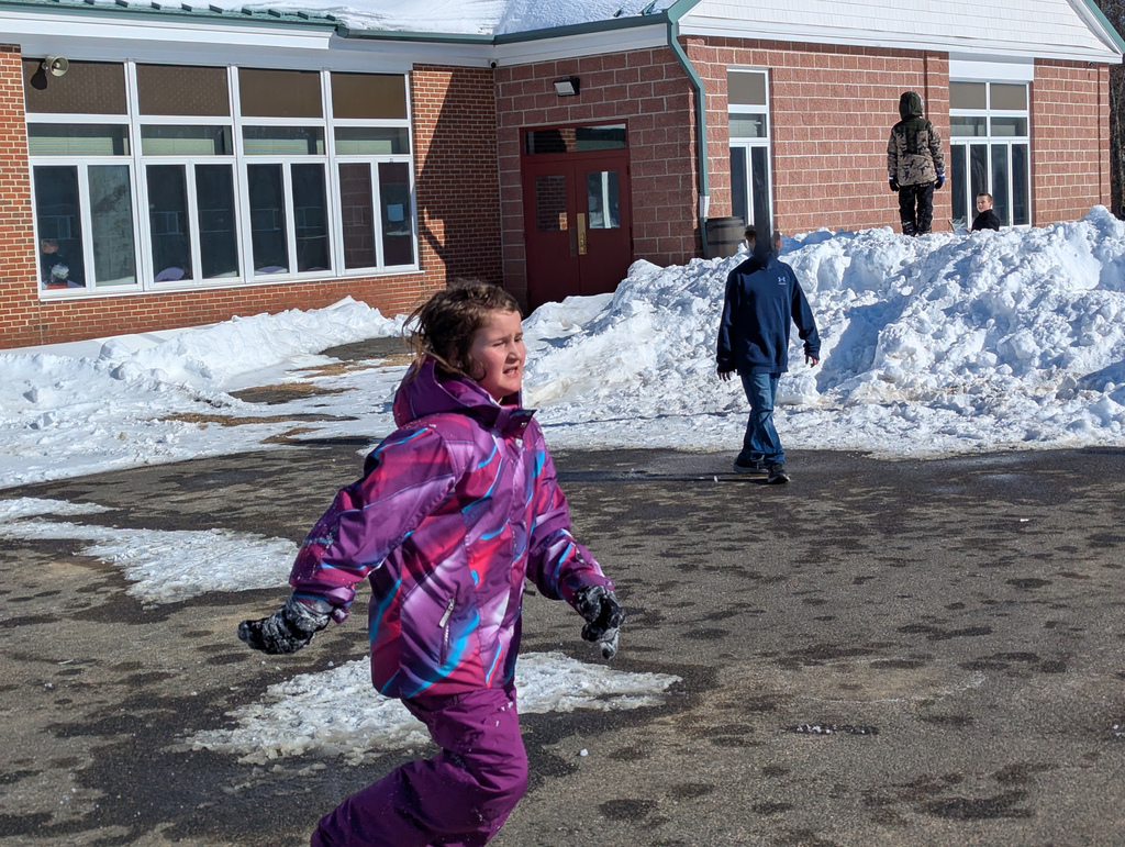 child in snow gear running