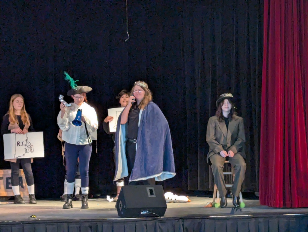 Student on stage in cape