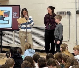 Boy and teacher getting award.