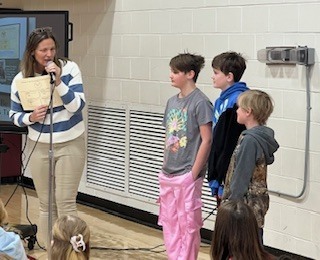 Three siblings getting award.