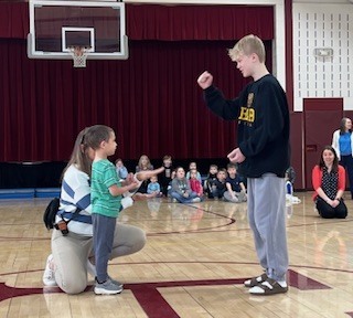 Older and younger male students playing game.