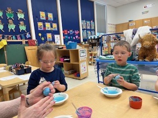 students making blue mixture wearing goggles