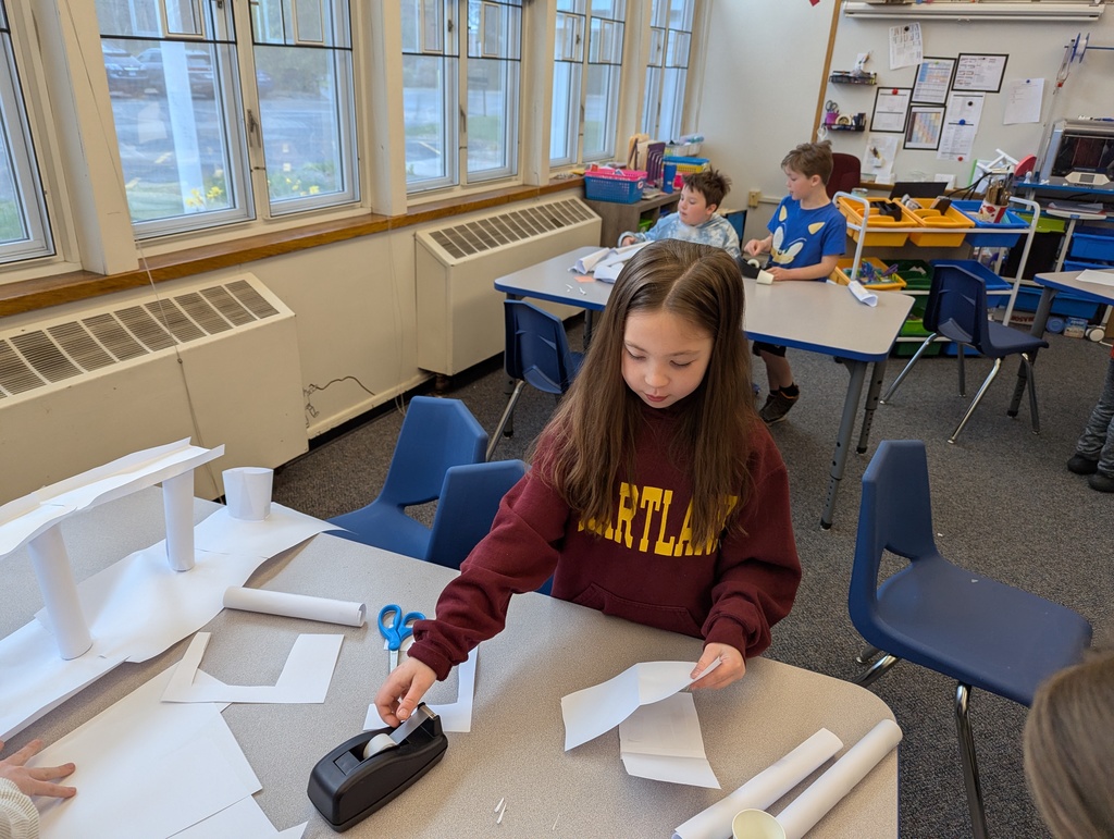 Girl taping paper at table