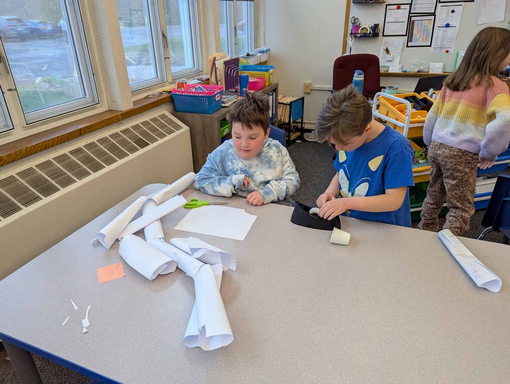 boys working together taping paper