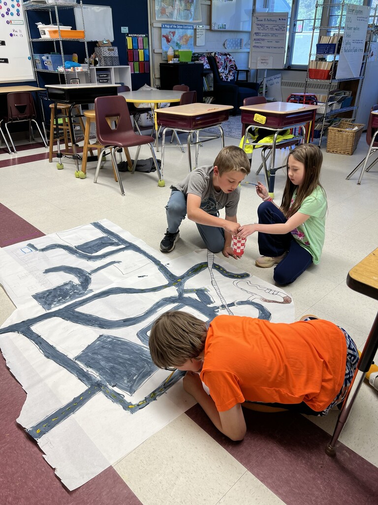 Kids drawing road on paper on florr