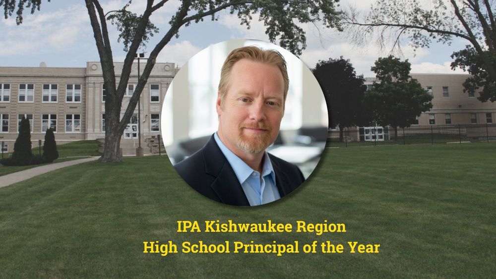 Principal Carl Hobbs in front of a photo of Harvard High School with the text IPA Kishwaukee Region High School Principal of the Year