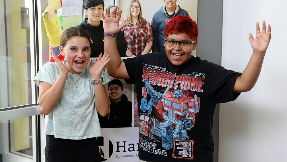 Two Students smile and are surprised