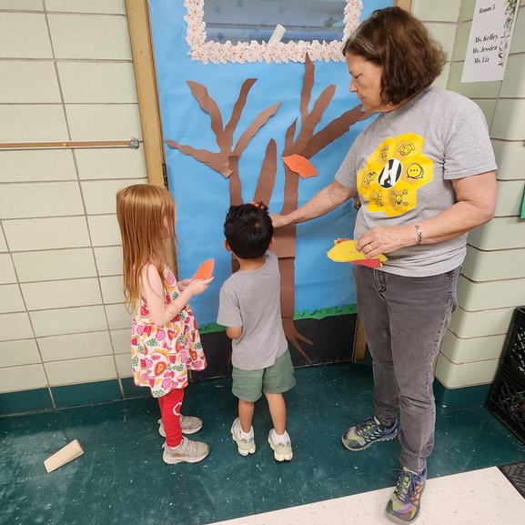 An ESP working with two students on door decorating