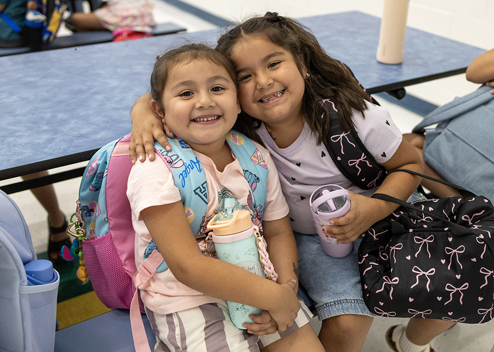 Two students smiling.