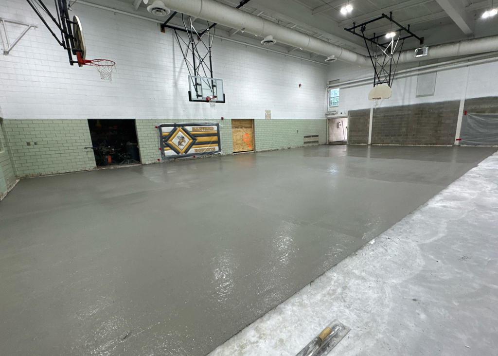 Newly poured concrete on gym floor.