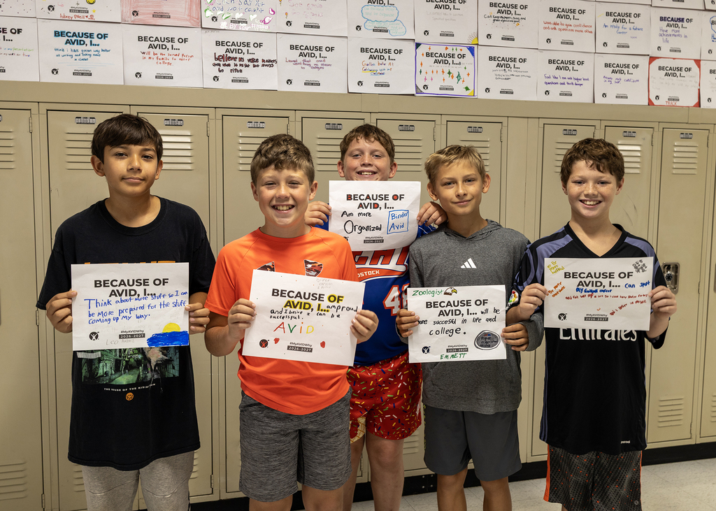 Students in hallway with AVID sign.