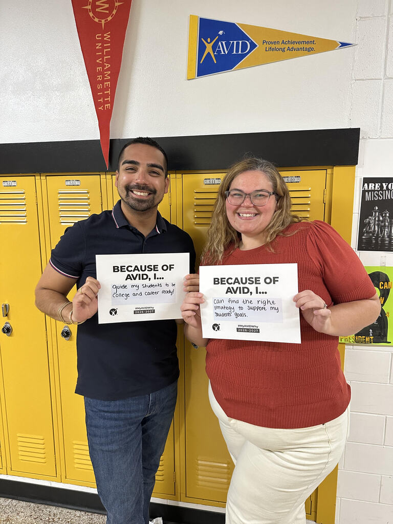 Teachers smiling with AVID Day signs.