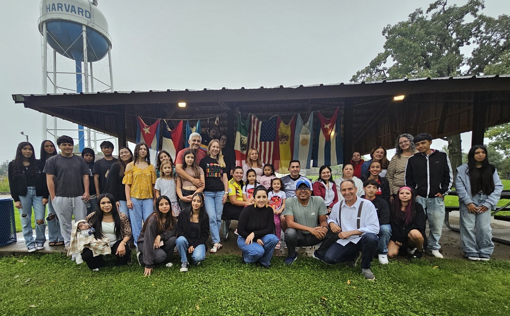 Group of students, families, and staff outside of a picnic pavilion.