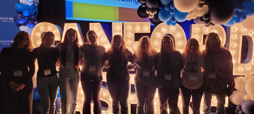 The girls in front of the "Sanford Aspire" lighted decorations