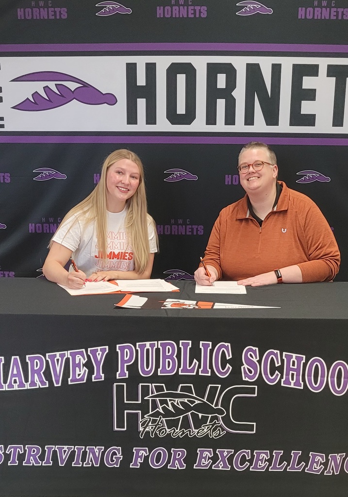 Kali and Alyson, Admissions director for UJ sign the scholarship acceptance forms
