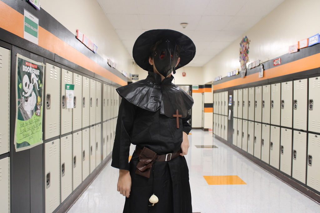 Kid posing in Halloween costume. 