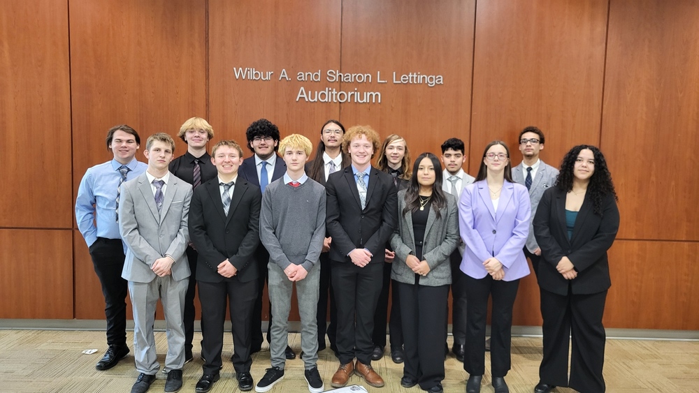 A photo of Hastings High School BPA students lined up against a wall for a posed photo.