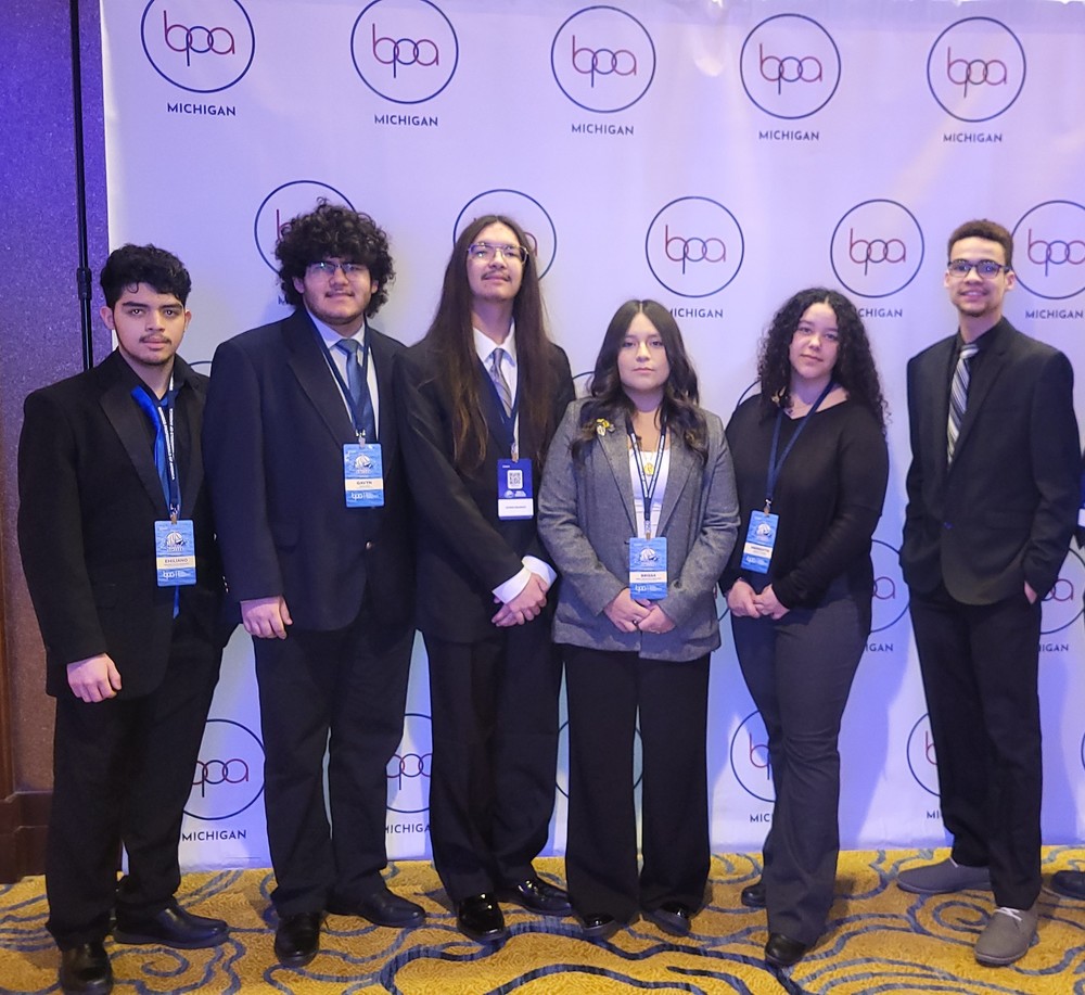 BPA students line up, wearing formal attire, to take a photo