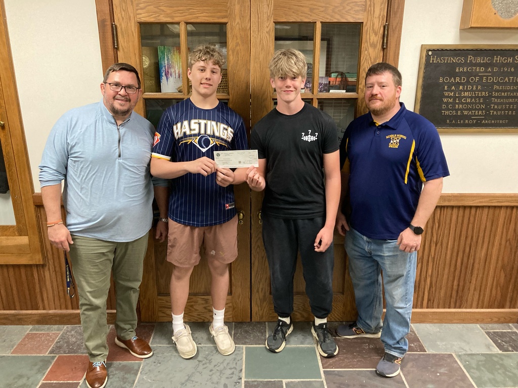 Myles Drake and Austin Friddle hold a check from the Barry Community Foundation