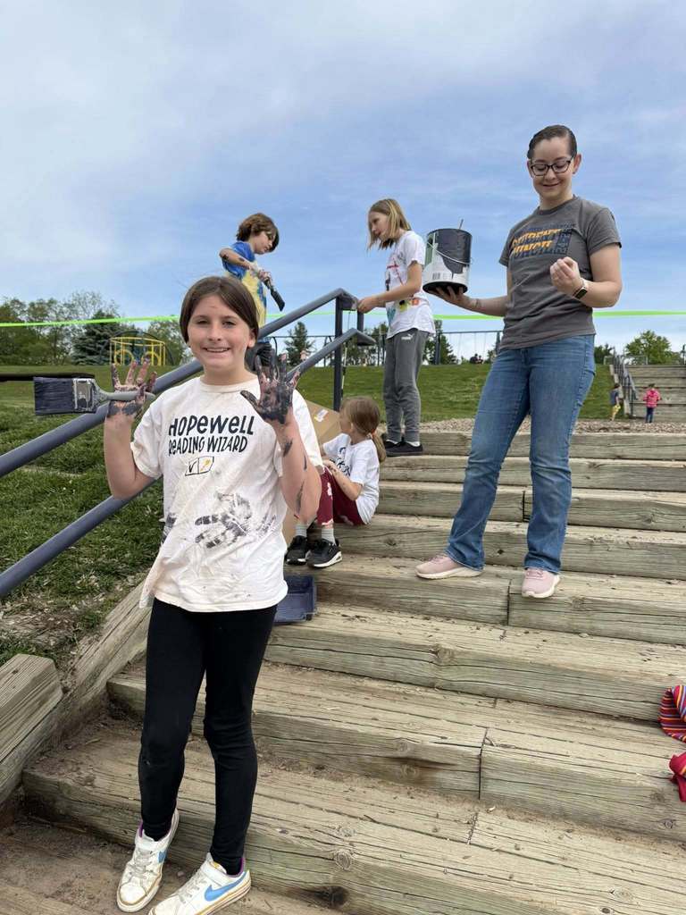Northeastern Elementary students painting a stair rail