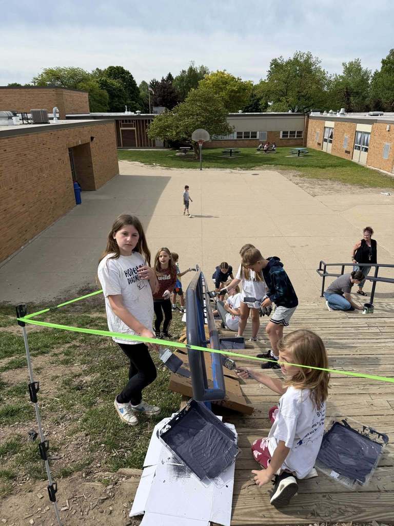 Northeastern Elementary students painting a stair rail