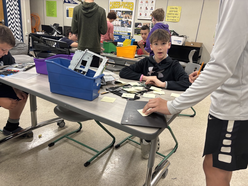 Middle school kids disassembling Chrombooks.