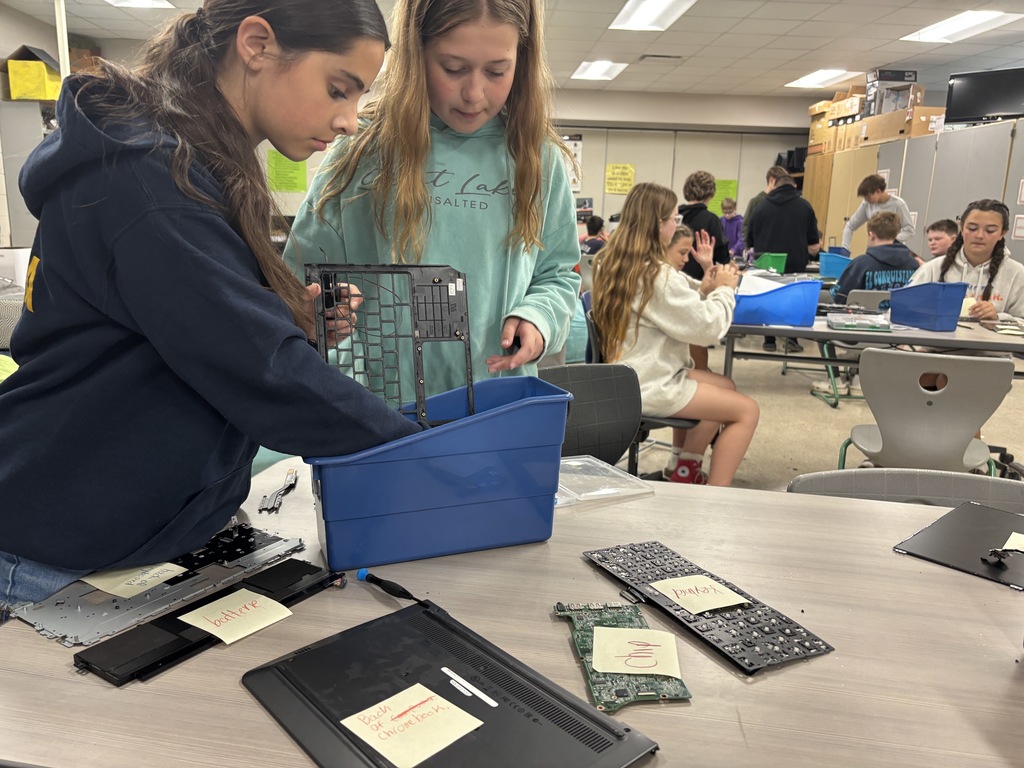 Middle school kids disassembling Chrombooks.