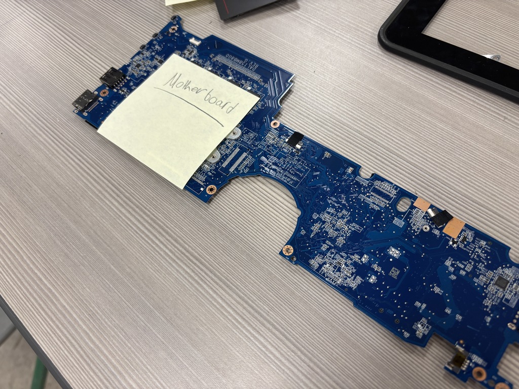 Middle school kids disassembling Chrombooks.