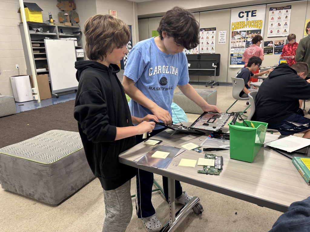 Middle school kids disassembling Chrombooks.