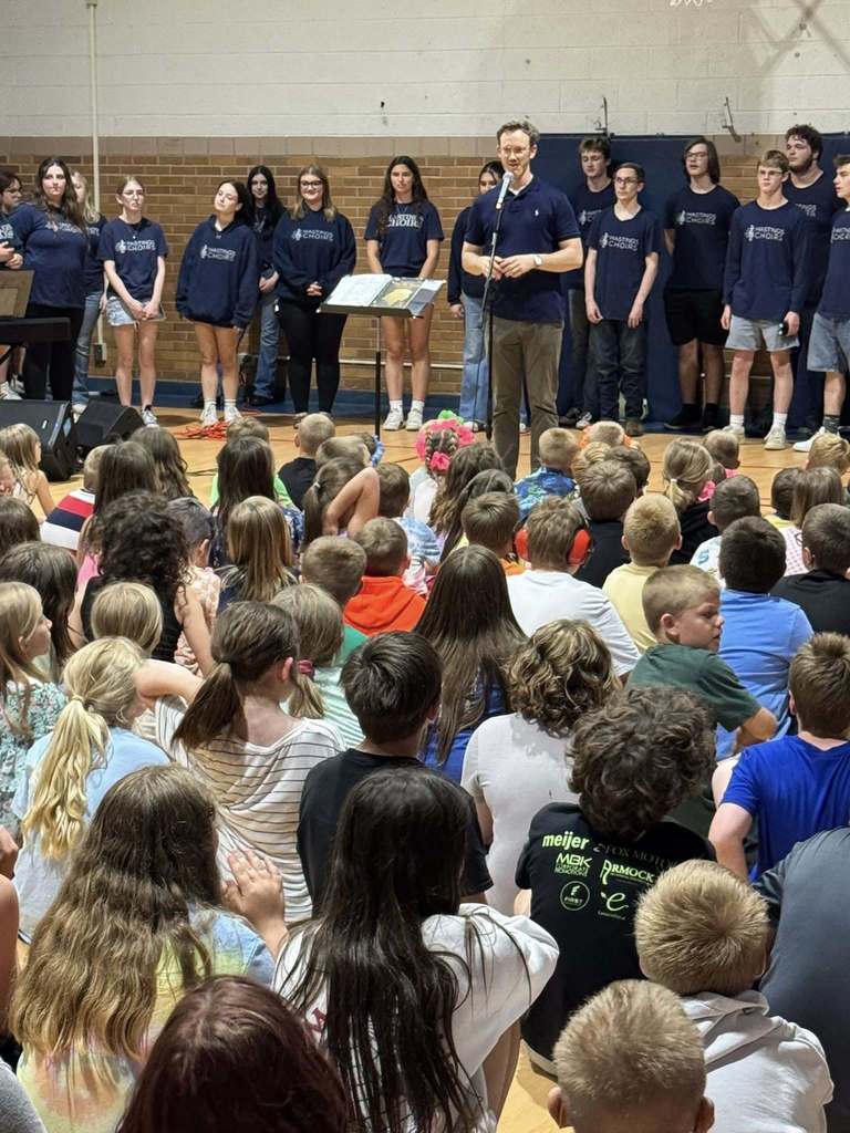 Hastings High School choirs performing for Northeastern Elementary students