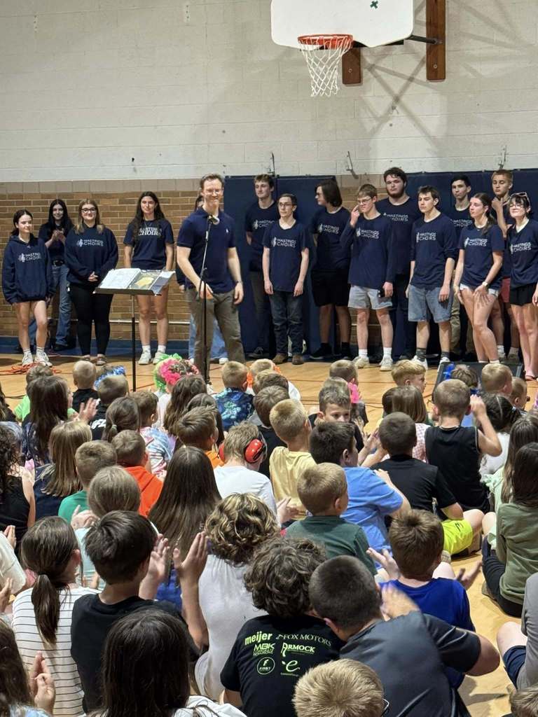 Hastings High School choirs performing for Northeastern Elementary students