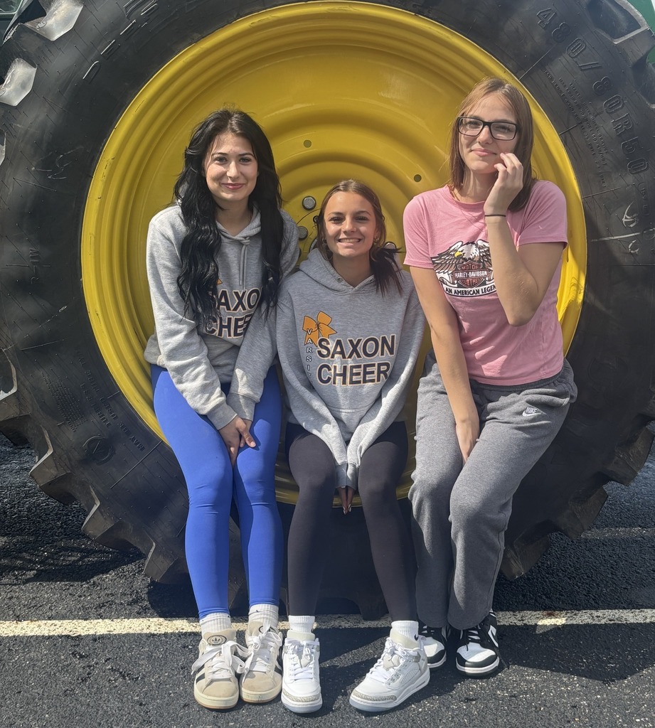 Students explore a large John Deere tractor.