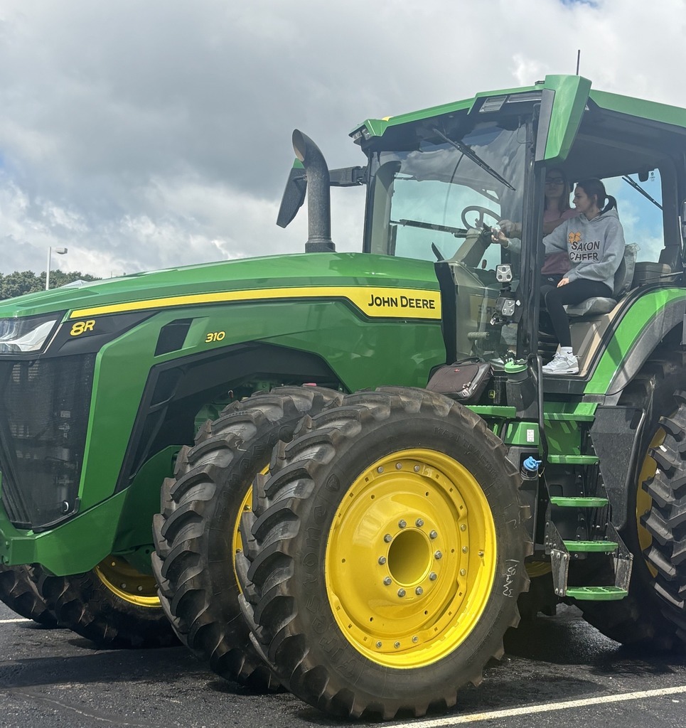 Students explore a large John Deere tractor.