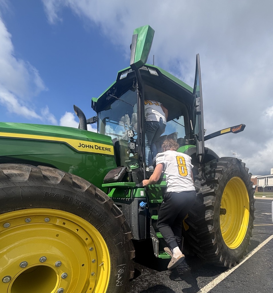 Students explore a large John Deere tractor.