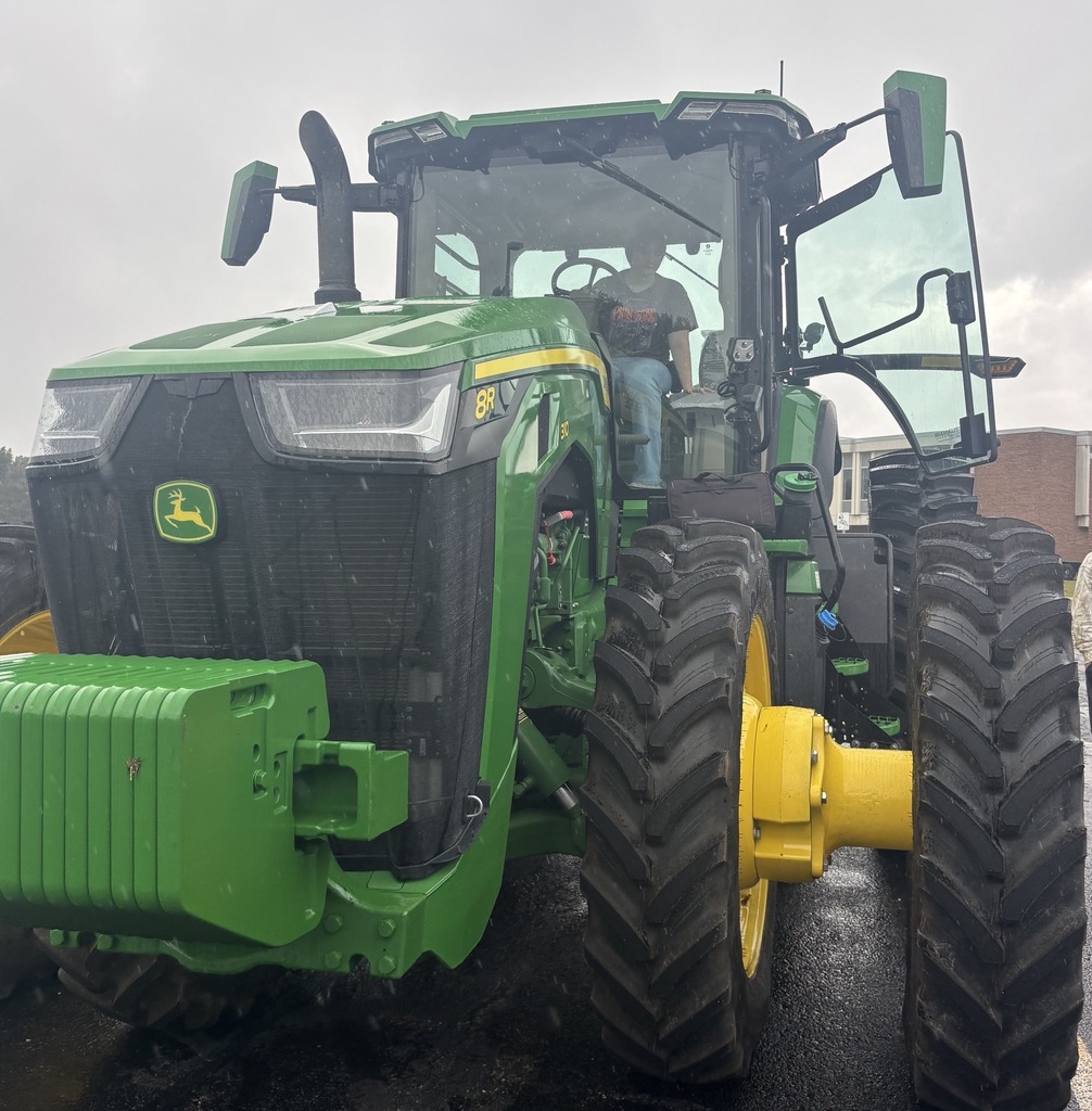 Students explore a large John Deere tractor.