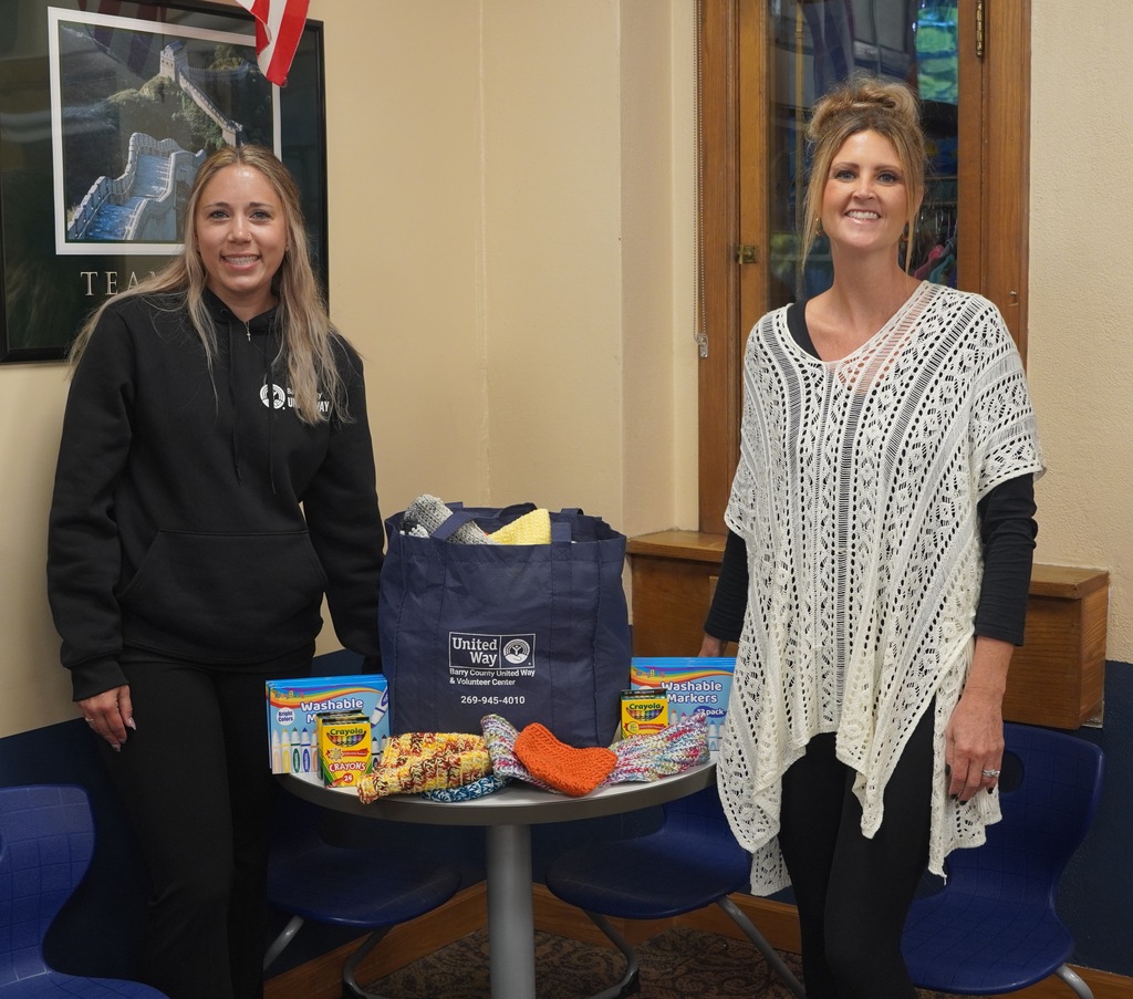 Morgan Johnson of the Barry County United Way pictured with Central Elementary Principal Amber Mitchell in front of a table of school supplies.