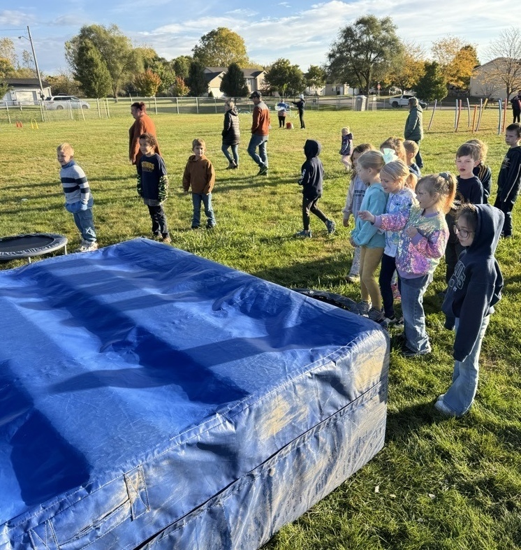 Students running over obstacles during the Rock-n-Run event at Northeastern Elementary.