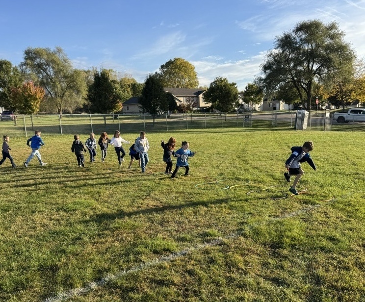 Students running over obstacles during the Rock-n-Run event at Northeastern Elementary.