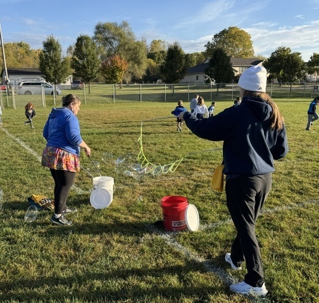 Students running over obstacles during the Rock-n-Run event at Northeastern Elementary.