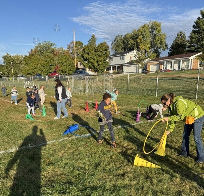 Students running over obstacles during the Rock-n-Run event at Northeastern Elementary.