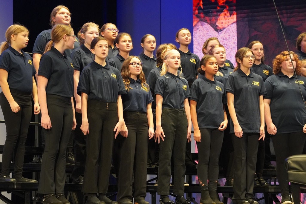 A close up view of several Hastings Middle School choir students singing