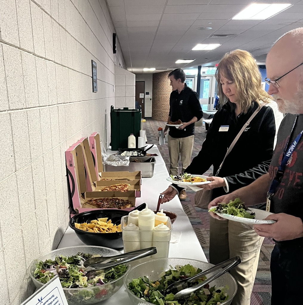 Workers at the Barry County College Fair scoop food on to their plates.