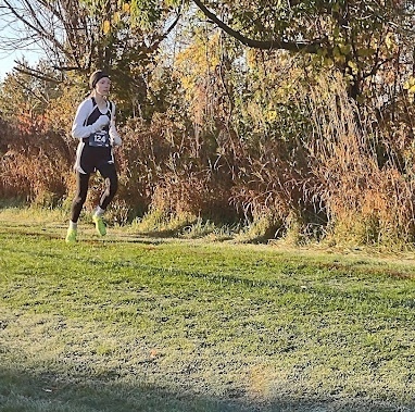 Caroline Randall runs along the course at South Christian High School during cross country regionals.