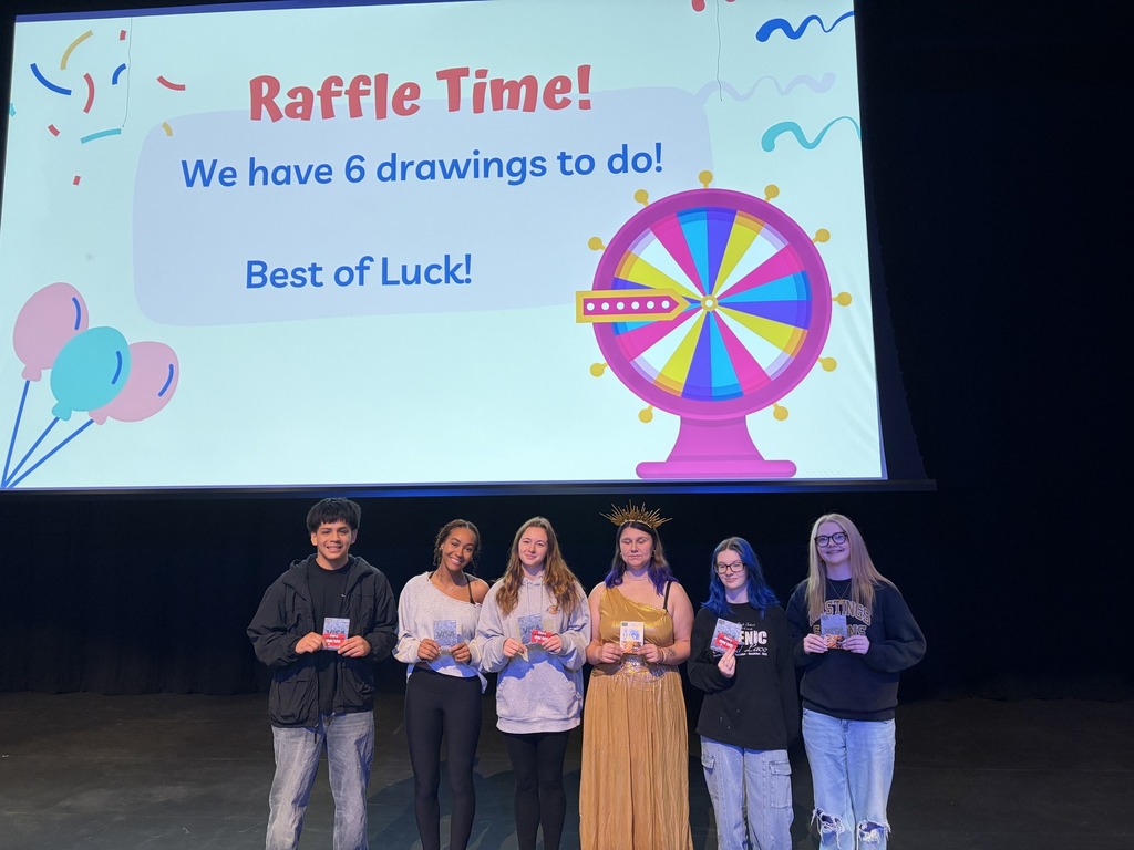 Students holding up gift cards they won in a raffle.