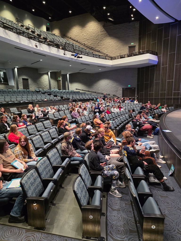 Many students siting in chairs at the Hastings Performing Arts Center
