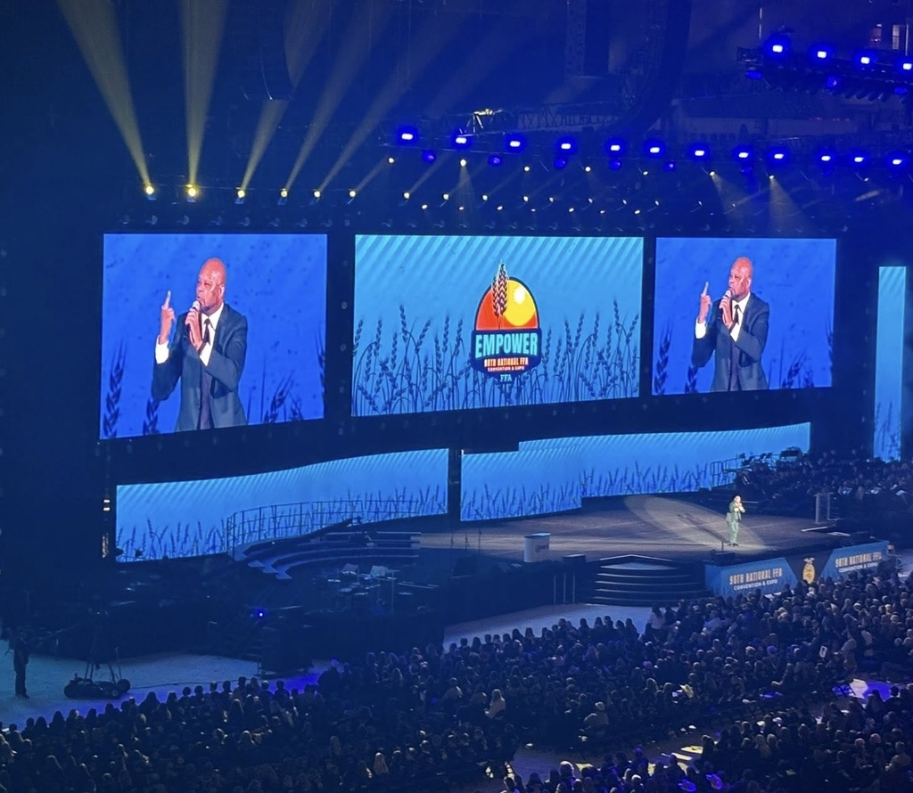 A speaker addresses a large crowd at Lucas Oil Stadium.
