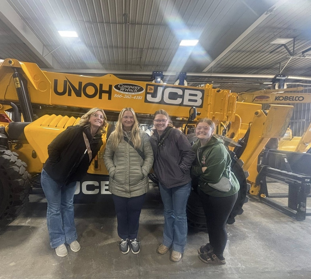 Students posed in front of machinery.