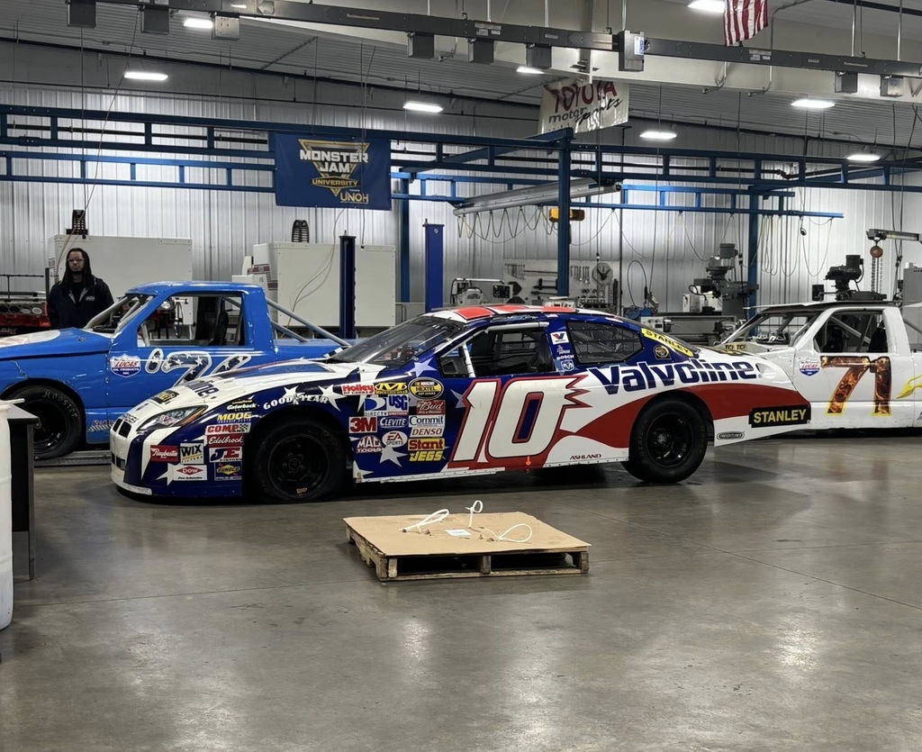 A NASAR race car parked in a garage.