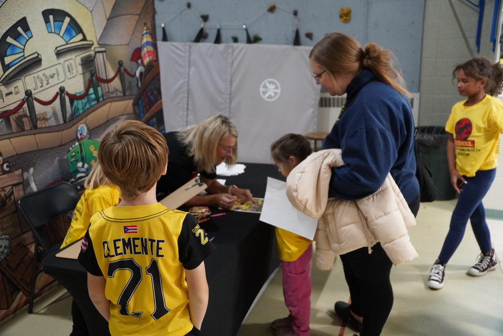 Students and parents look closely at a dinosaur display at Star Elementary.