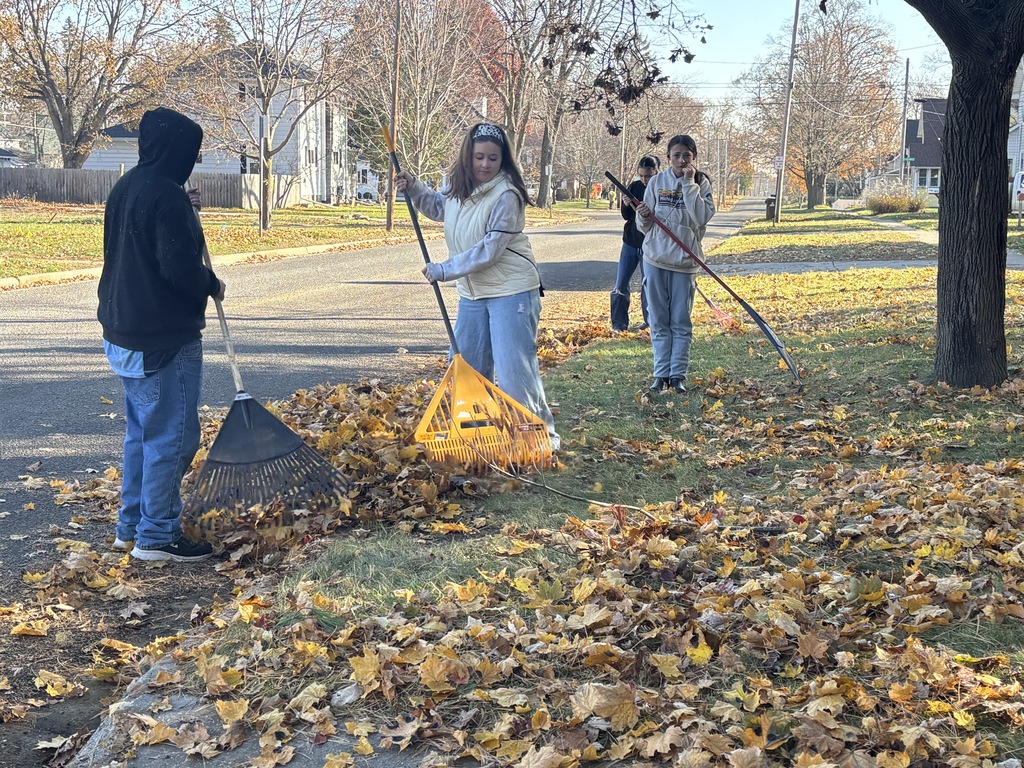 Hastings Middle School students rake leaves at homes throughout the city.